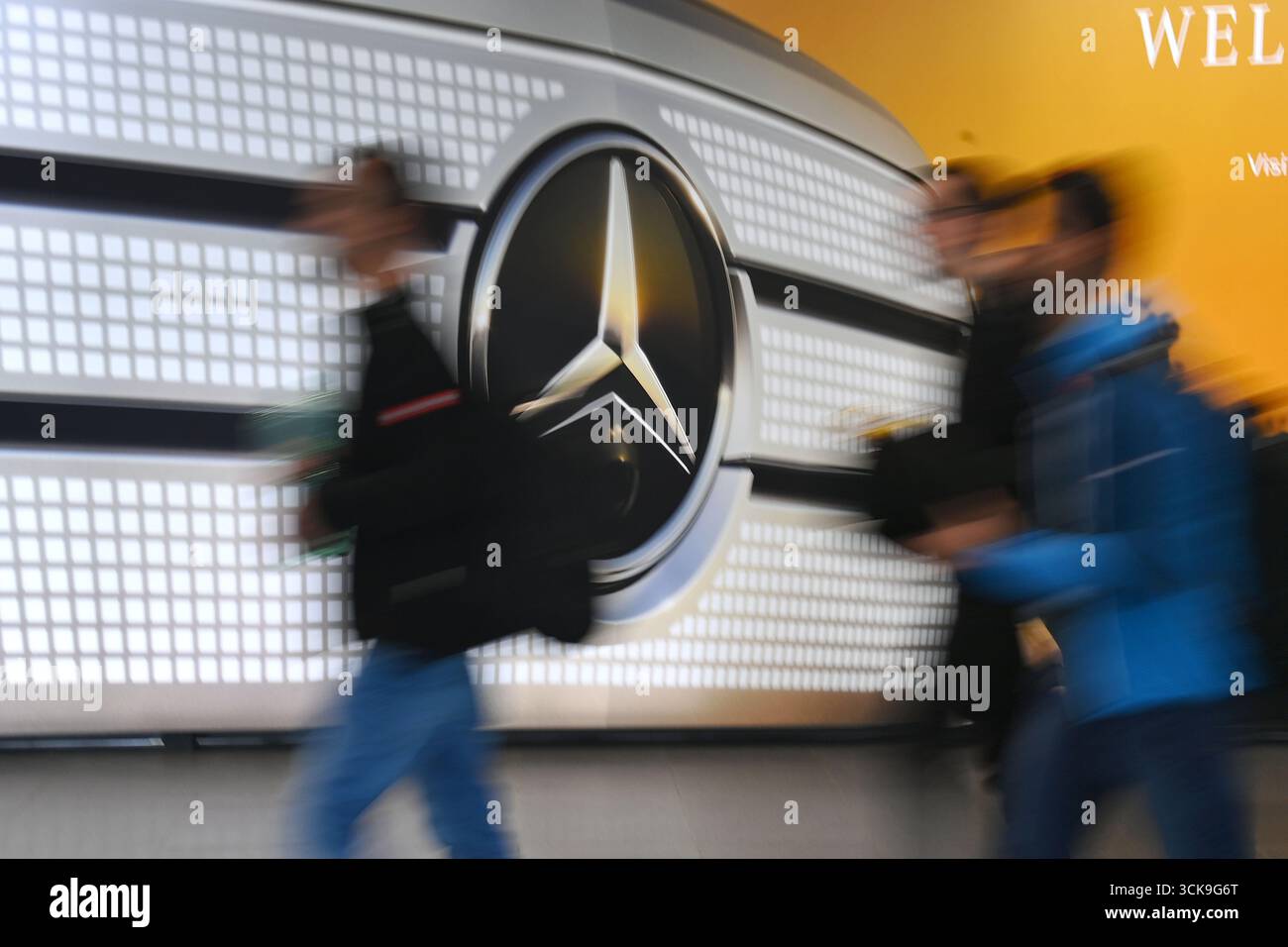 People in front of the Mercedes star, logo, company logo, brand emblem, brand logo. IAA Mobility 2025 at the Munich Trade Fair Center from September 9th to 14th, 2025. Stock Photo