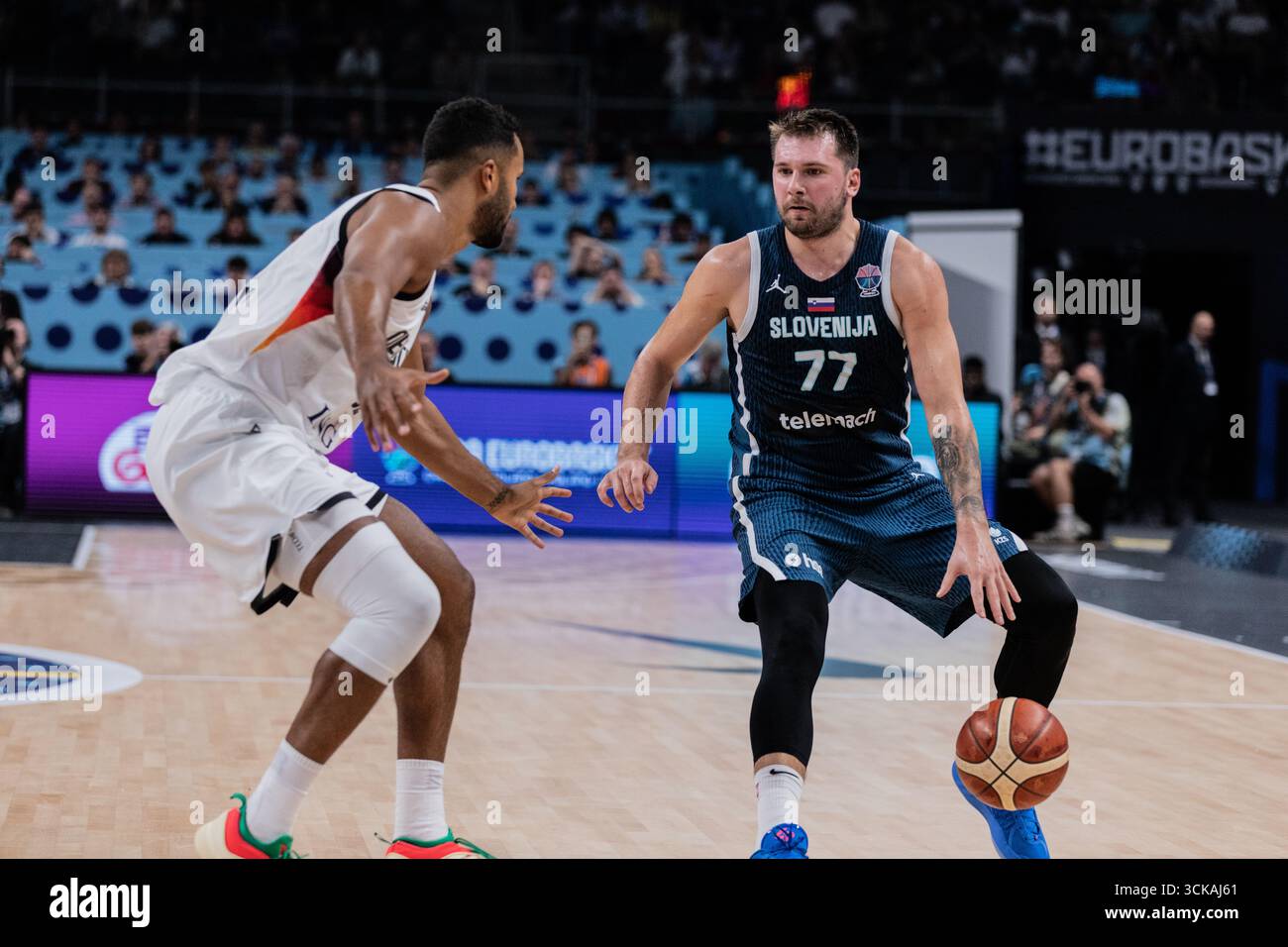 Luka Doncic (R) of Slovenia and Johannes Thiemann (L) seen in action ...
