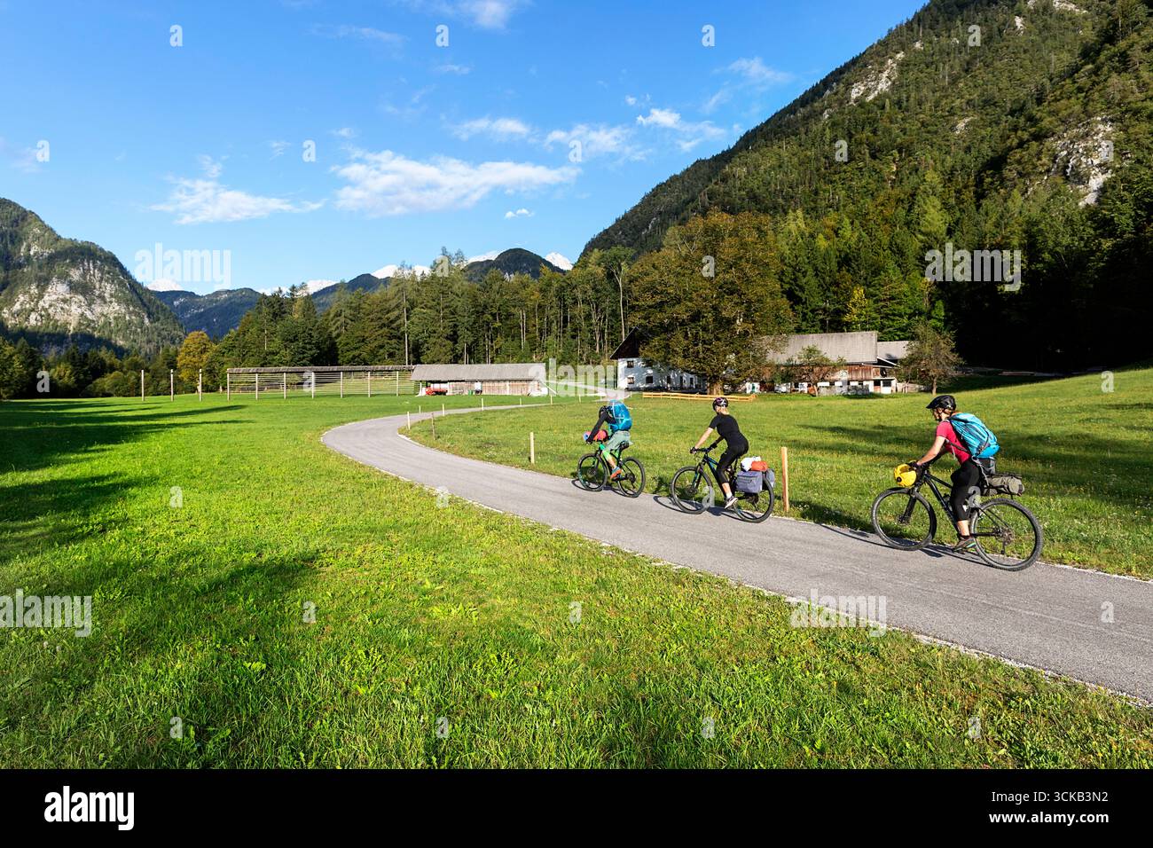Tourists on a cycling, bikepacking trip around Slovenia, exploring beautiful mountain landscape in radovna valley in triglav national park Stock Photo