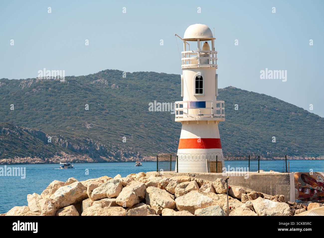 July Lighthouse Kas, Antalya, Turkey - July 9, 2025: White and red lighthouse on Kas ...