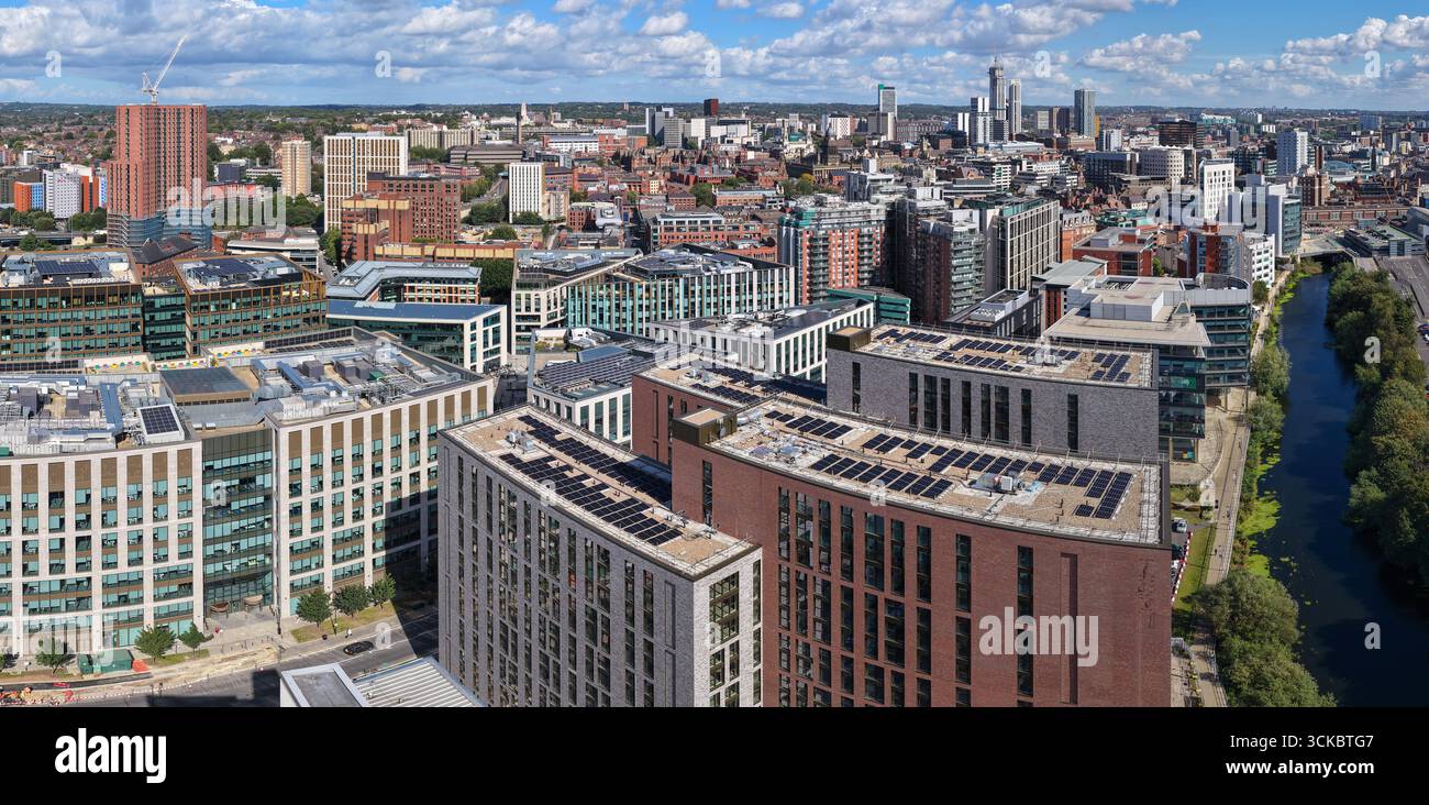 Panoramic aerial view of Leeds city centre in West Yorkshire, highlighting modern buildings with rooftop solar panels. Stock Photo