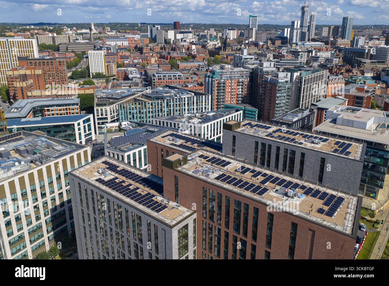 Aerial view of Leeds city centre in West Yorkshire, highlighting modern buildings with rooftop solar panels. Stock Photo