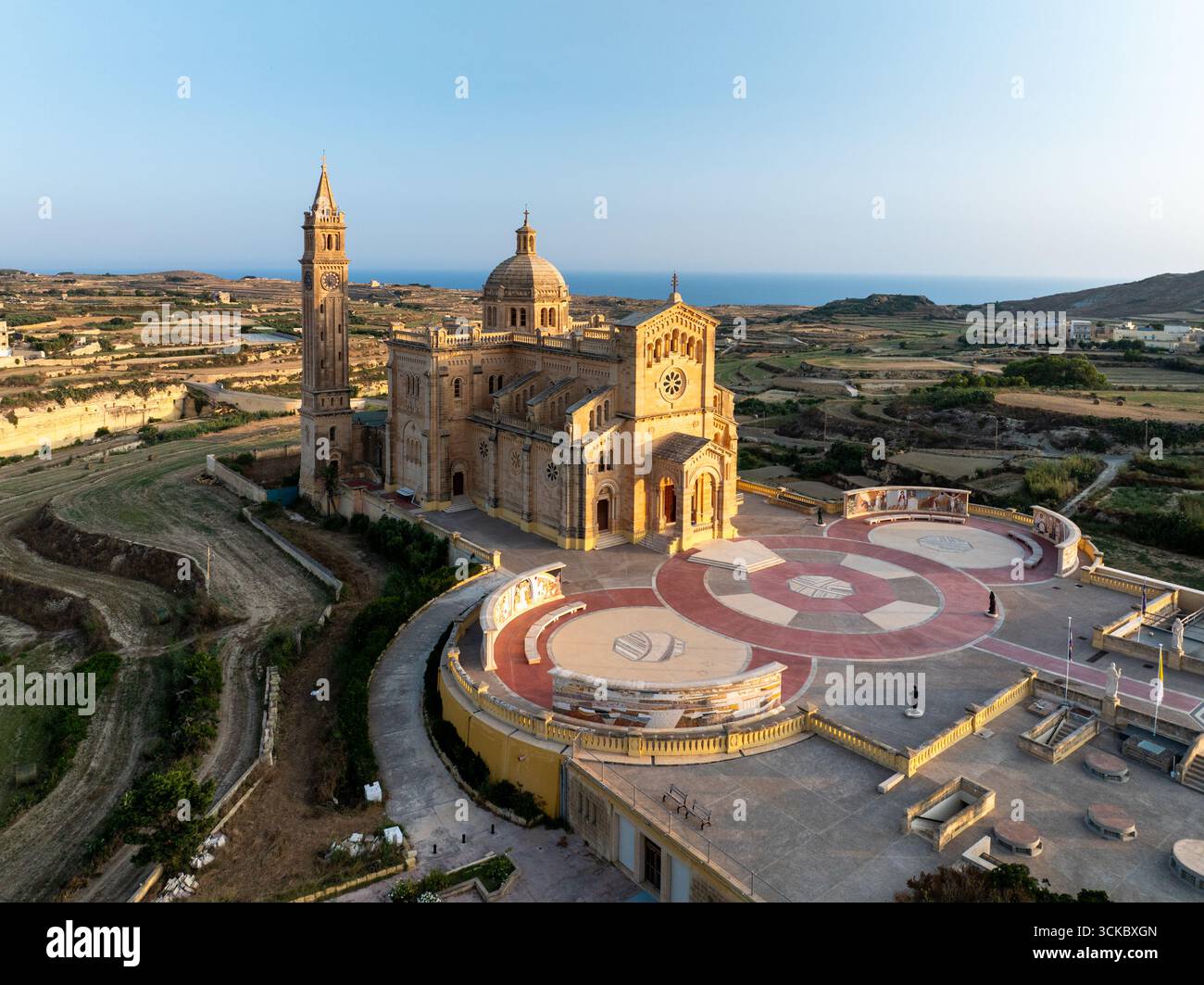 Rustic Basilicas Aerial view of the majestic Ta' Pinu Basilica standing tall against the ...