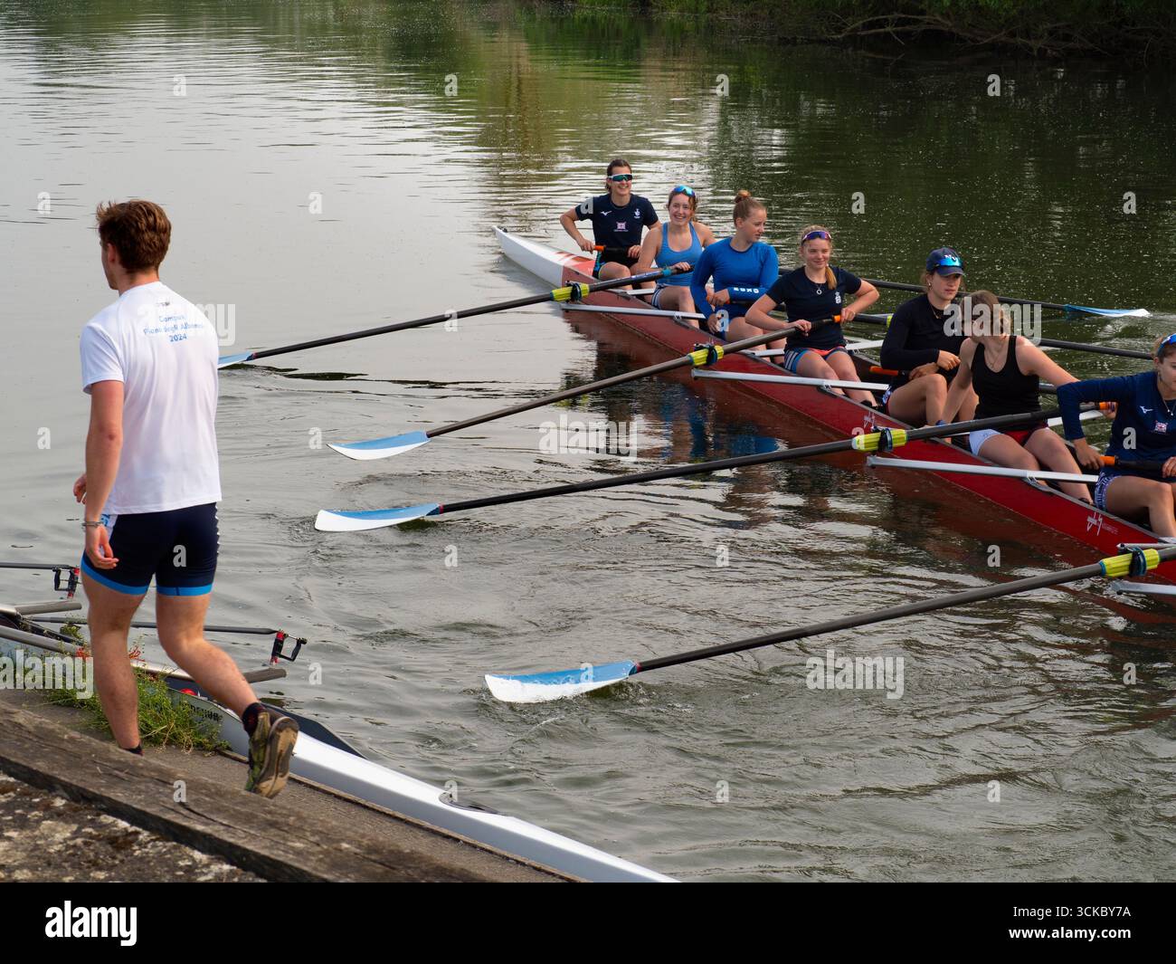 Local Rowing Boathouse Two people talking during sunrise hi-res stock photography and images ...