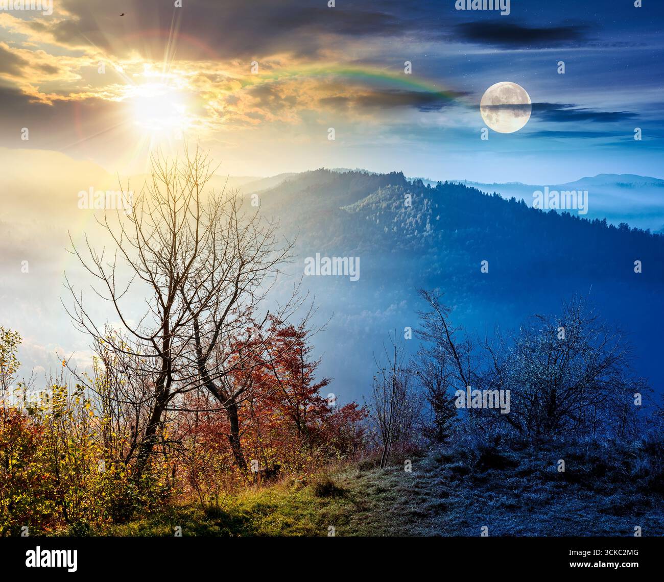 view from a mountain in to the foggy valley. day and night time change concept. beautiful autumn equinox. forested hills with sun and moon at twilight Stock Photo