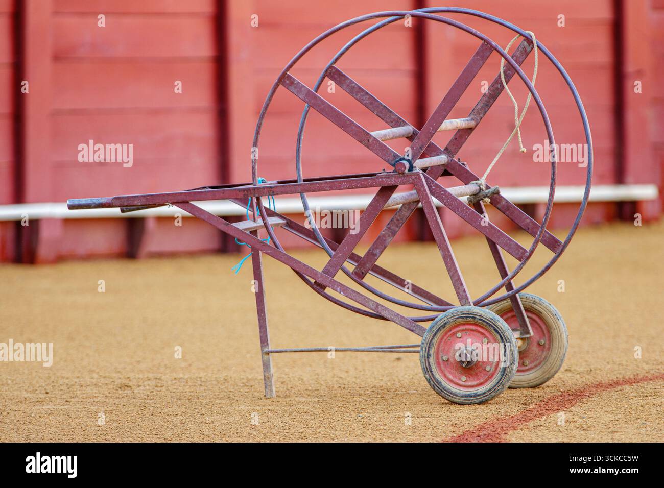 A marking cart sits on the sandy ground at Real Maestranza Bullring, an essential tool in bullfighting traditions in Seville, Andalusia, Spain. Stock Photo