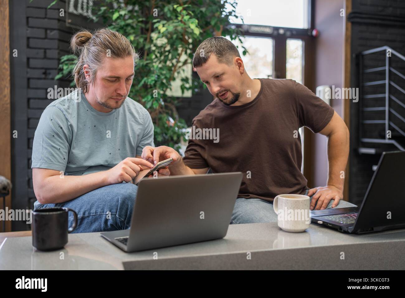 Engaging in a Collaborative Workspace Interaction between Two Dedicated Professionals Stock Photo