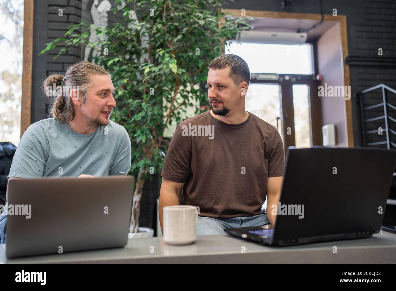 Team of programmers coding on laptops working at creative office Stock Photo