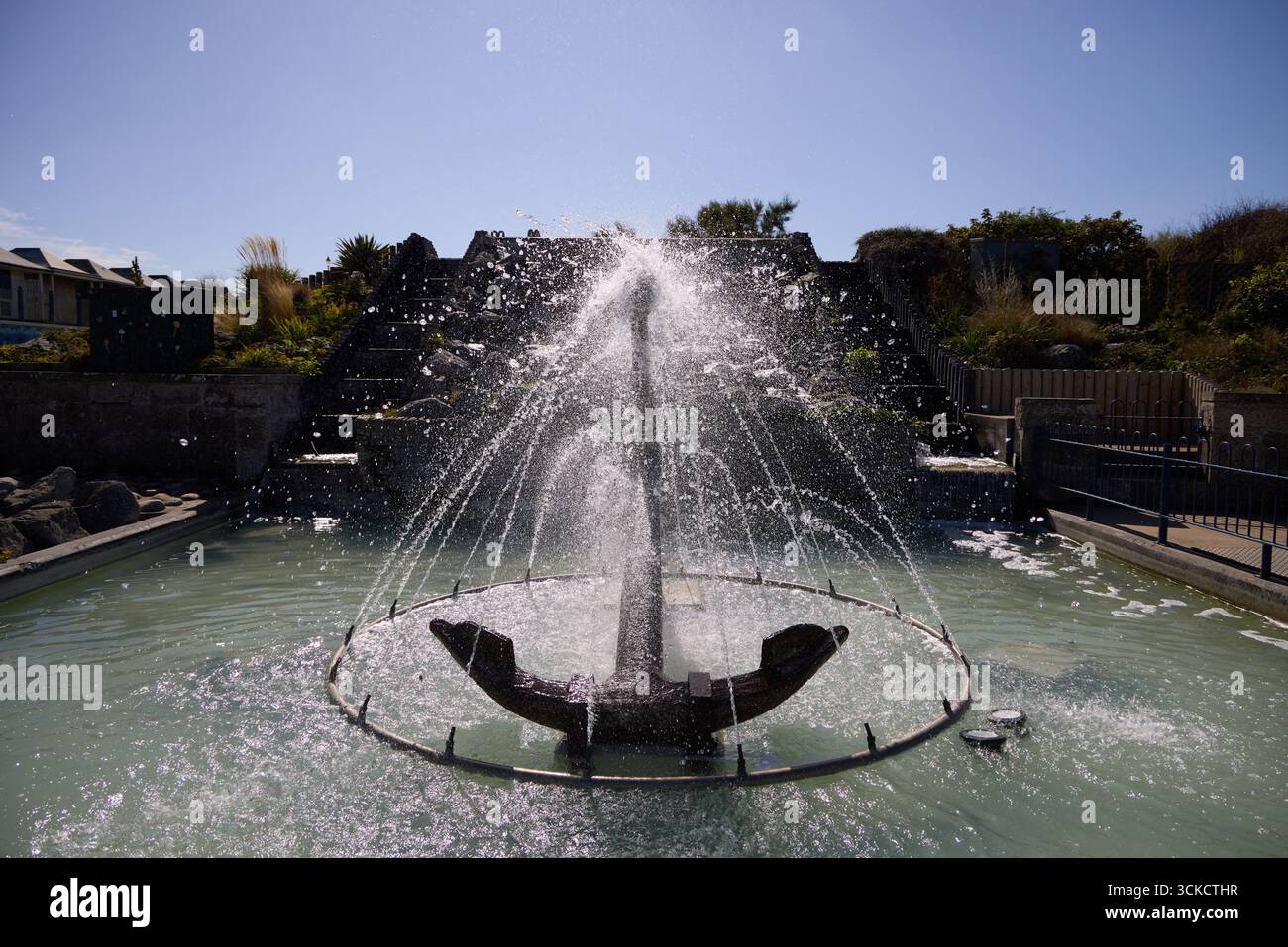 Anchor sculpture and water feature at Sutton-on-Sea, Lincolnshire, England. Decorative seaside landmark combining maritime heritage with public art in Stock Photo