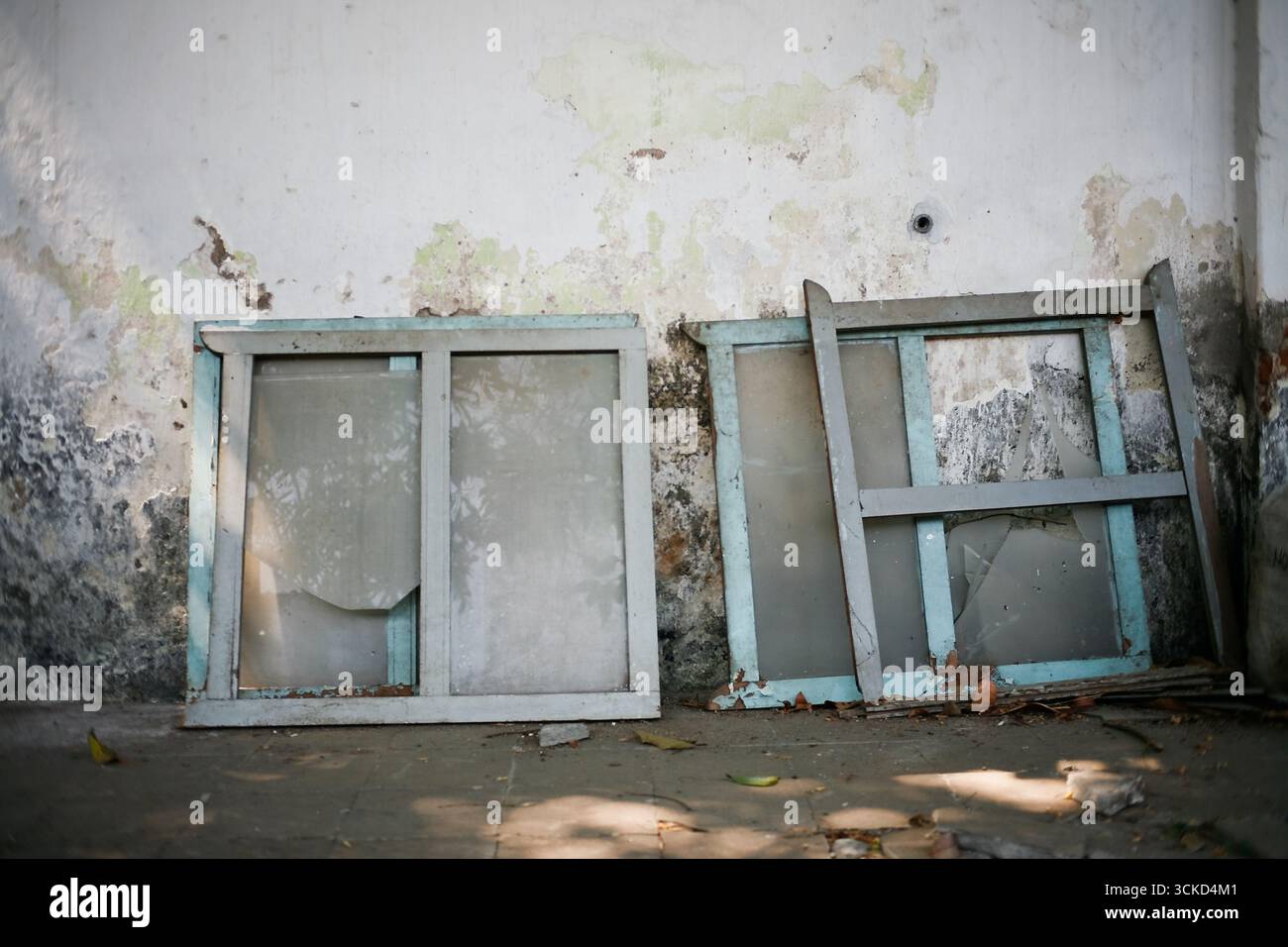 broken window frame leaning on he wall Stock Photo