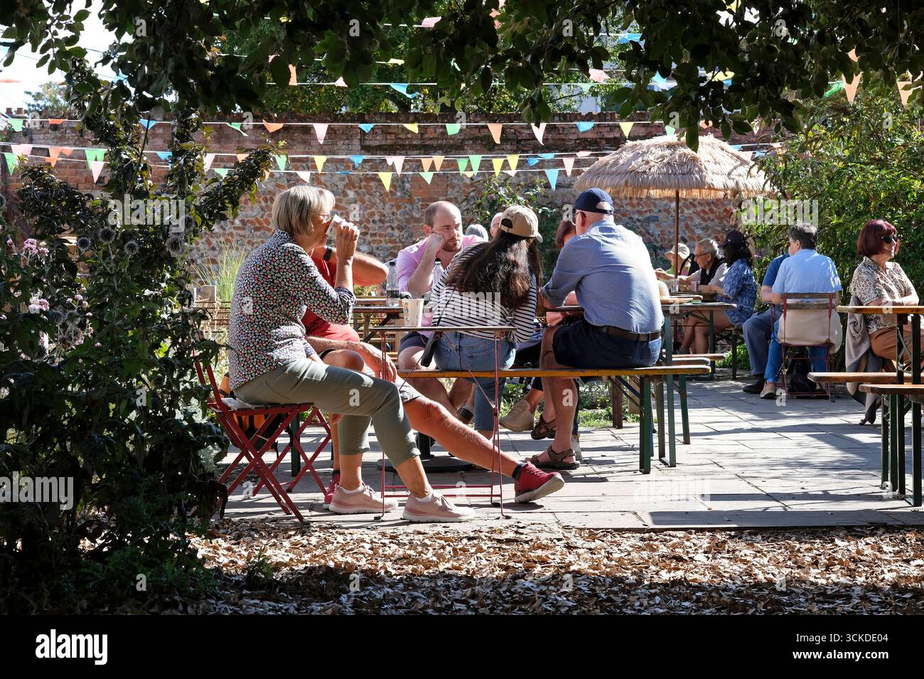 people sitting in cafe garden, wells-next-the-sea, north norfolk, england Stock Photo