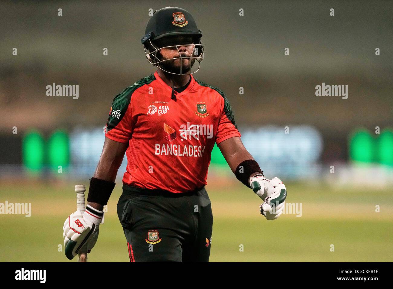Bangladesh's Parvez Hossain Emon walks off the field after losing his ...