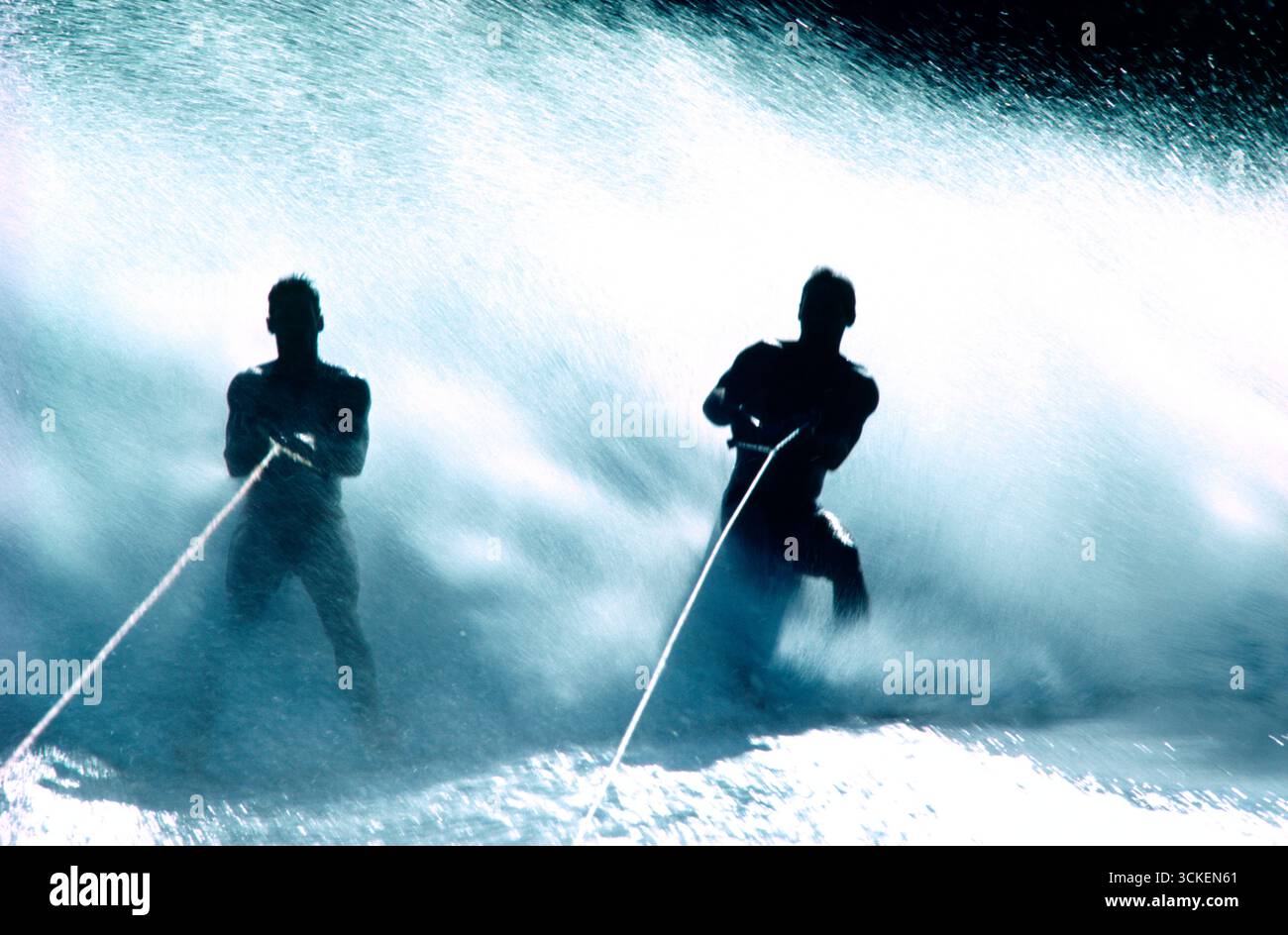 Australia. Queensland. Two young men water skiing barefoot. Stock Photo