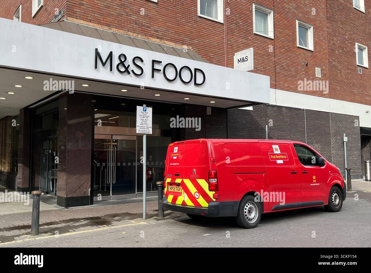 M&S Food Storefront with a Royal Mail Van parked outside. Cardiff, Wales, United Kingdom. 12th April 2025. - Smartphone Captured Stock Image