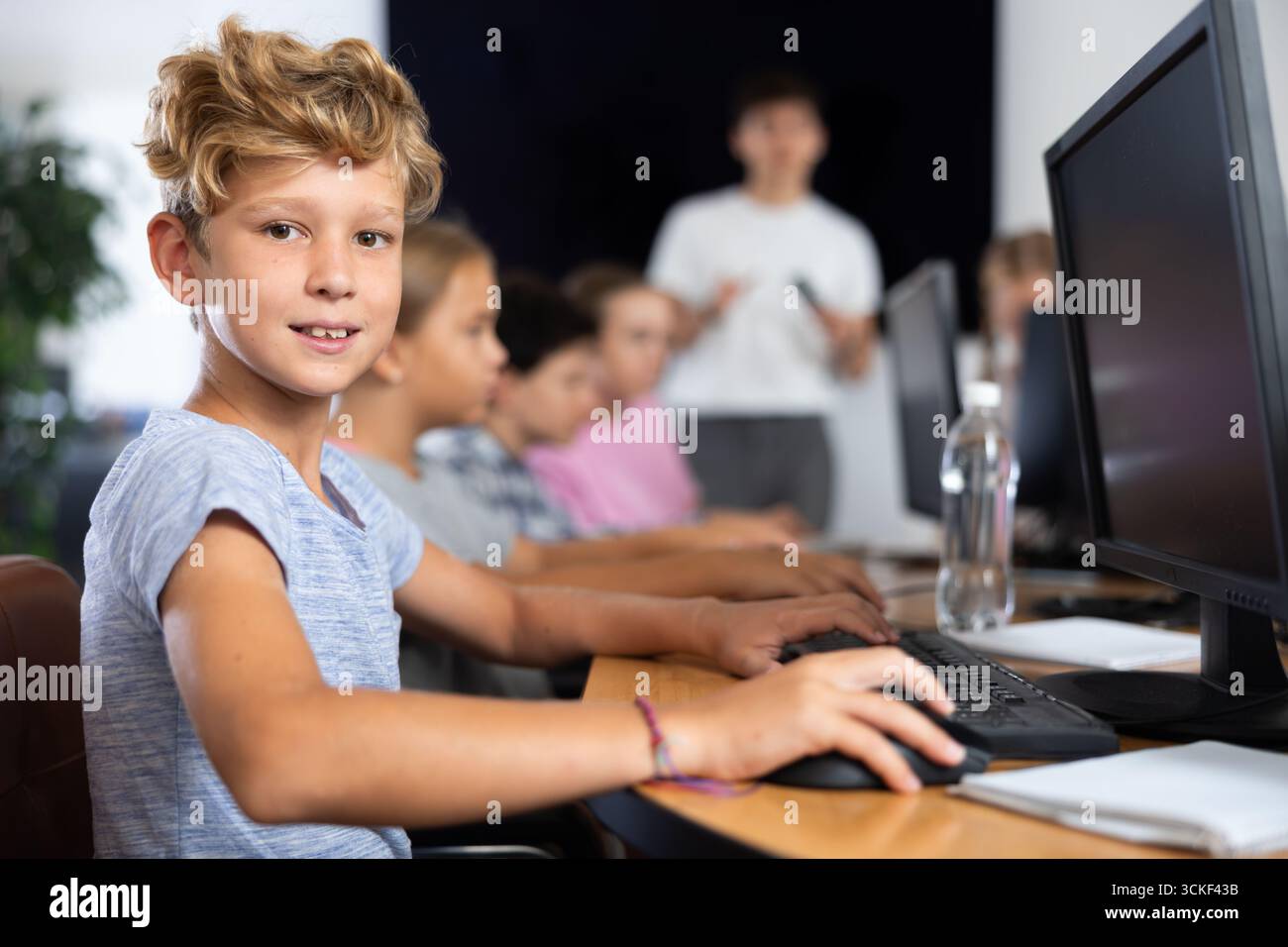 Learning Boy With Computer Boy student learning to work on computer in classroom Stock Photo - Alamy