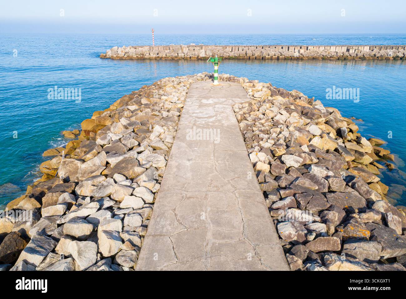 A beautiful and scenic aerial view of a long stone breakwater The Path to the End of the Journey Stock Photo