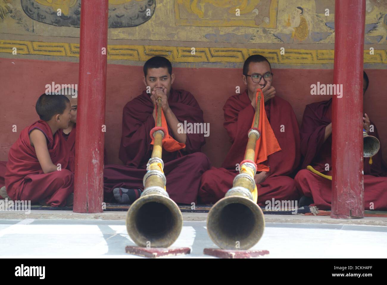 A groups Buddhist monk in traditional Tibetan horn or Dangchen ...