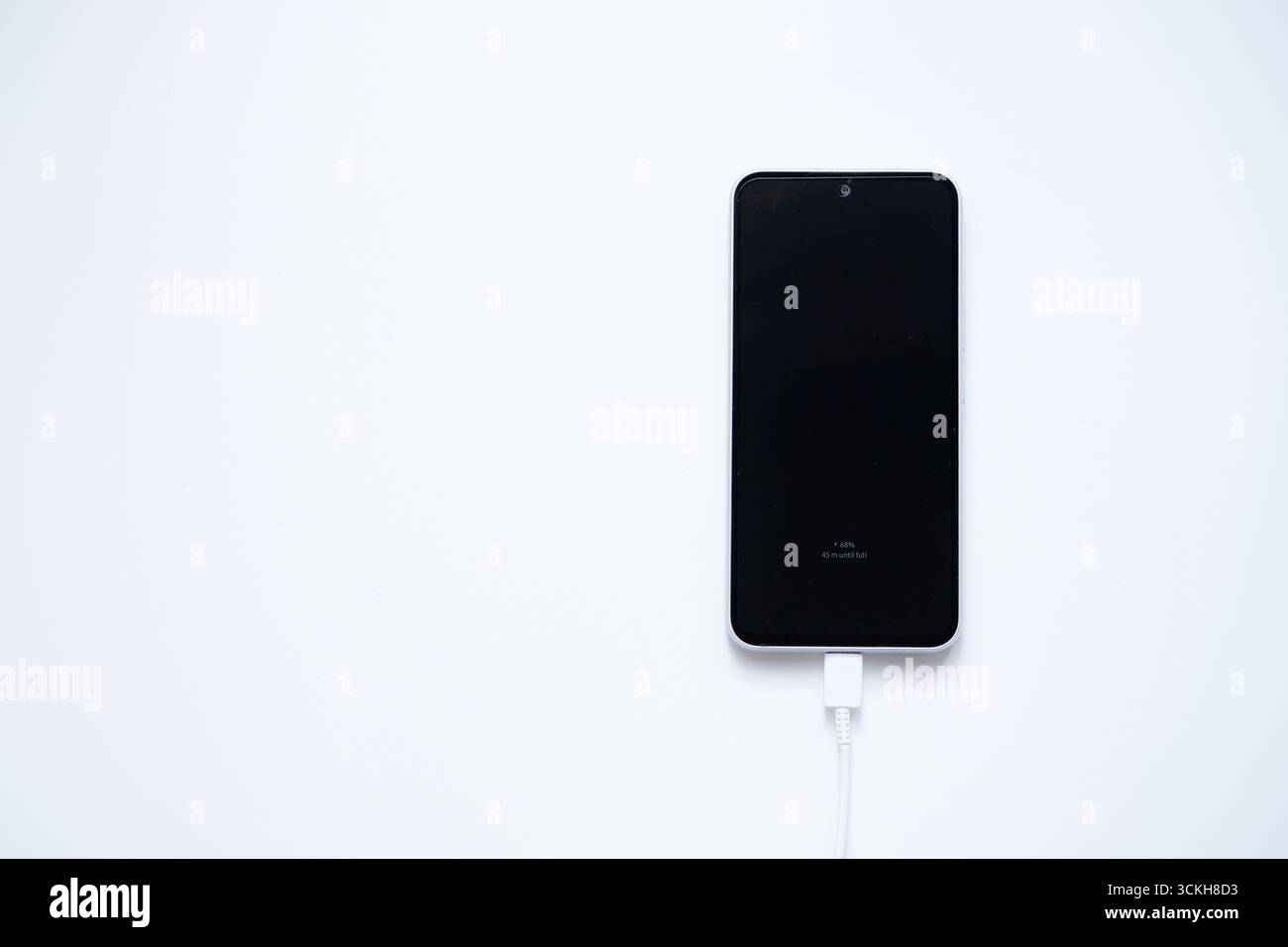 Charging mobile phone battery, isolated on white background Stock Photo
