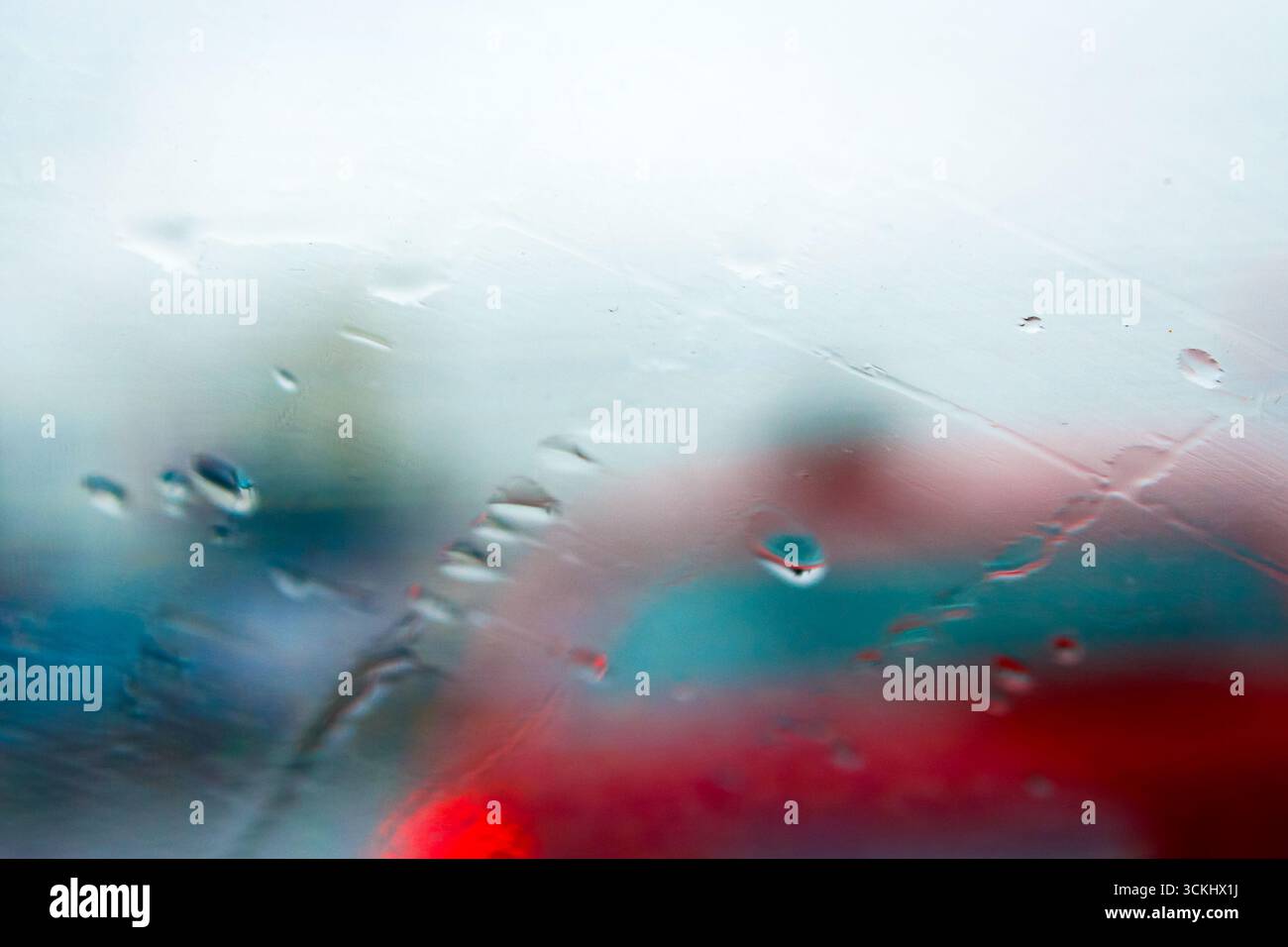 abstract background raindrops on glass. background of blurred urban landscape on a rainy day. wet window with bokeh effect Stock Photo
