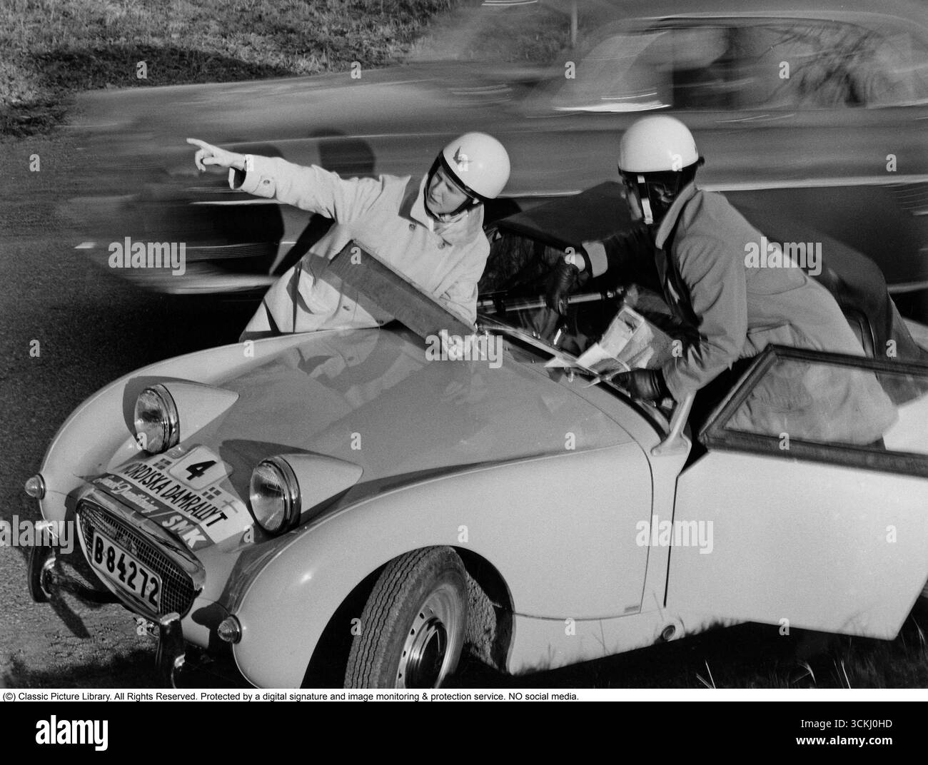 Austin-Healey Sprite MK1 Frogeye: Icon of 1960s Rally Spirit. In this vibrant 1960 image from the Nordic Women's Rally, two female participants stand beside their Austin-Healey Sprite MK1 'Frogeye,' a compact British sports car celebrated for its cheeky, frog-like headlights and revolutionary monocoque body design. Launched in 1958 by Donald Healey Motor Company under BMC, the Sprite offered affordable fun with a 948cc A-series engine delivering 43 hp, rear-wheel drive, and a lightweight 1,500 lbs frame—ideal for spirited driving and motorsport. Its significance lies in democratizing sports ca Stock Photo