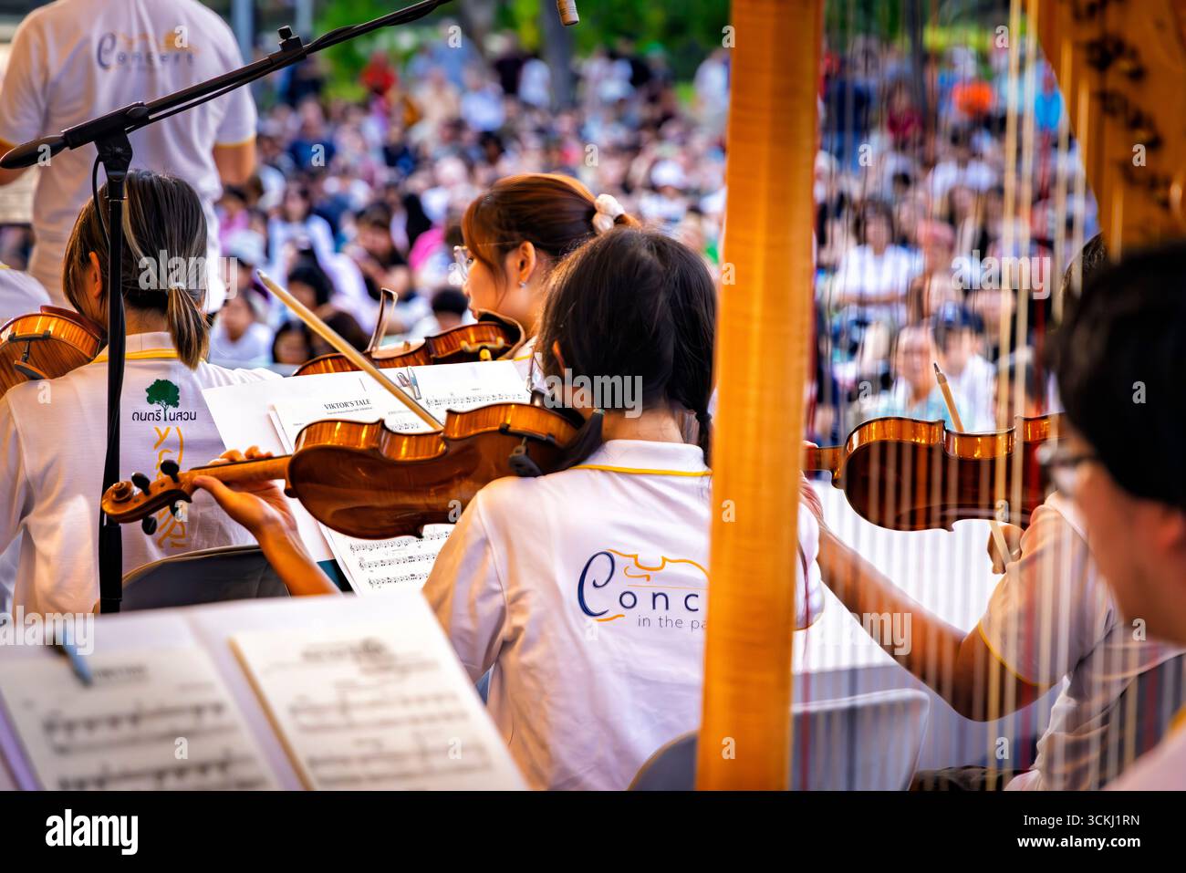 Musicians on stage playing in open air classical music concert in Lumphini Park, Bangkok, Thailand Stock Photo