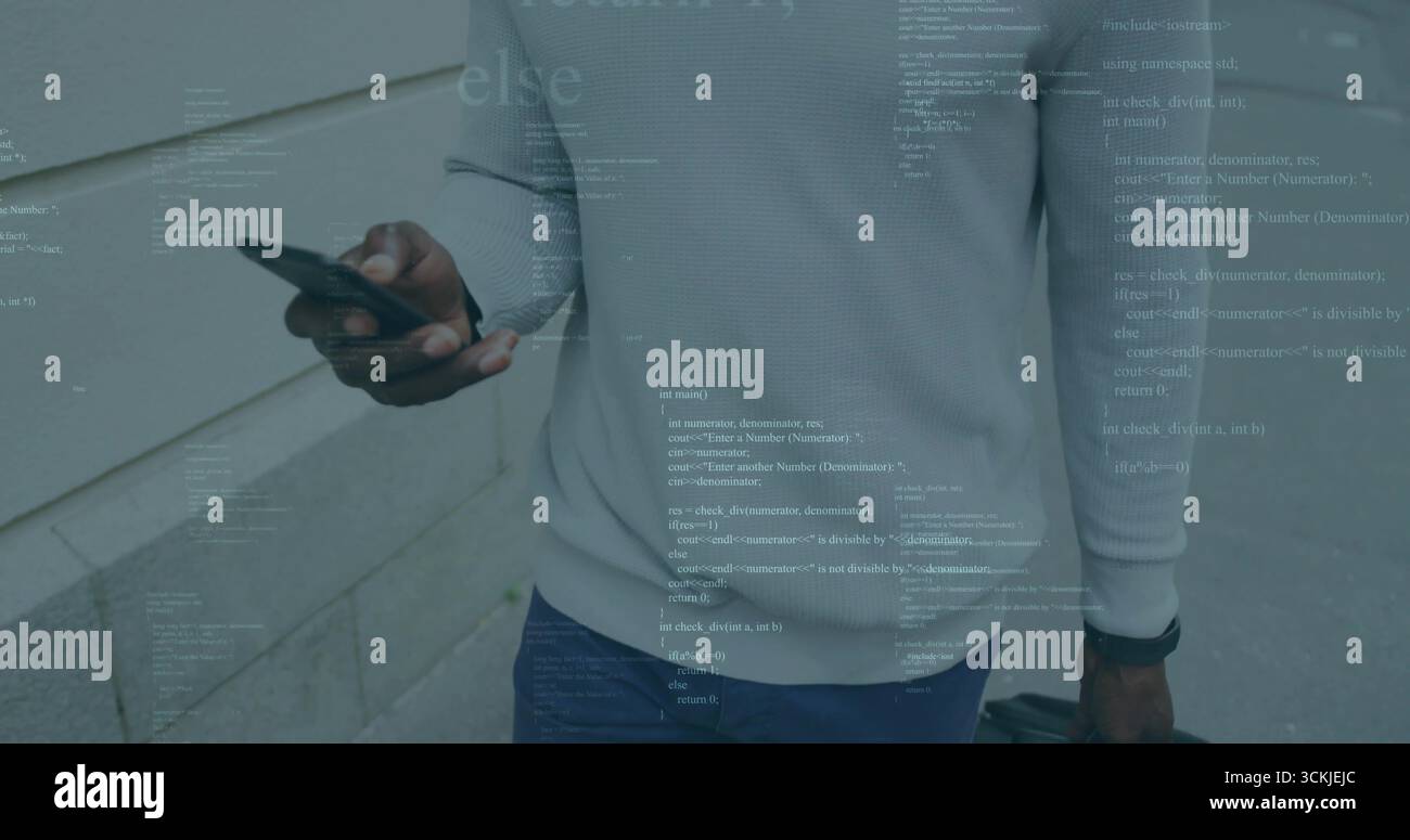 Mature man in sweater pulling suitcase using smartphone on sidewalk beside stone facade, with code Stock Photo