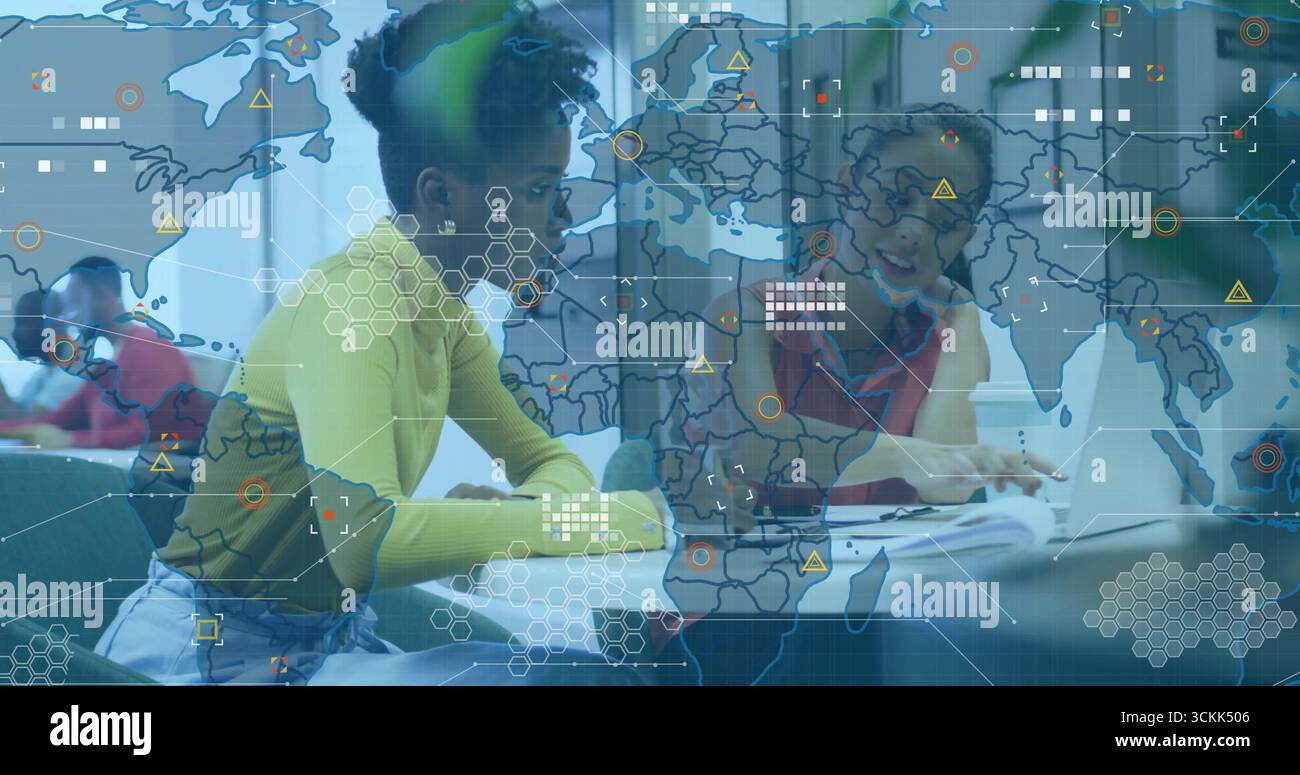Four students collaborating around study table, with laptops notebooks textbooks digital overlay Stock Photo