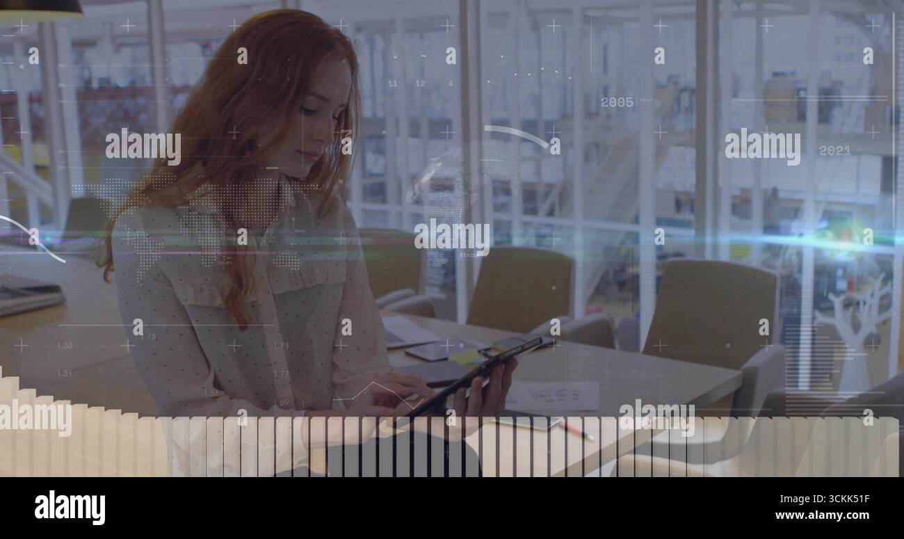 Leaning forward professional woman reviewing tablet at atrium lounge ...