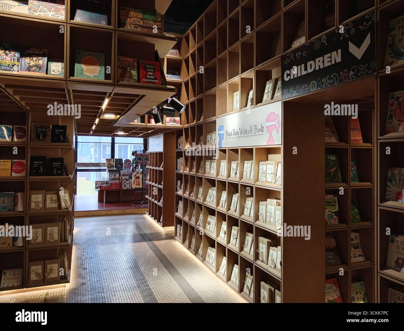 Cle Rex Bookstore Kuala Lumpur, Malaysia - March 3, 2025: Innovative wooden shelves fill ...