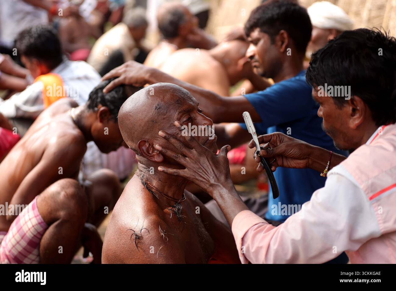 Small Head Ritual Prayagraj, India. 12 Sep.2025. A man gets his head shaved as part of ...
