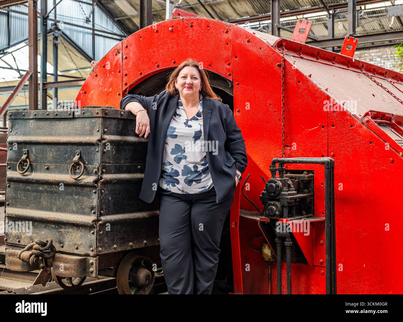 Portrait of Kirsty McNeill (Scottish MP) with coal truck or wagon, National Mining Museum, Newtongrange, Midlothian, Scotland, UK Stock Photo