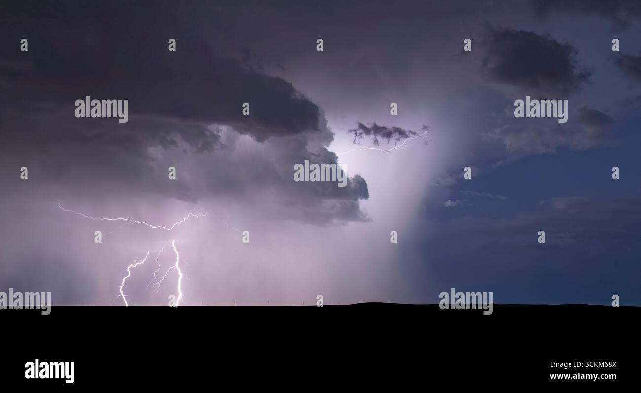 Powerful lightning bolt strikes from a summer monsoon storm Stock Photo