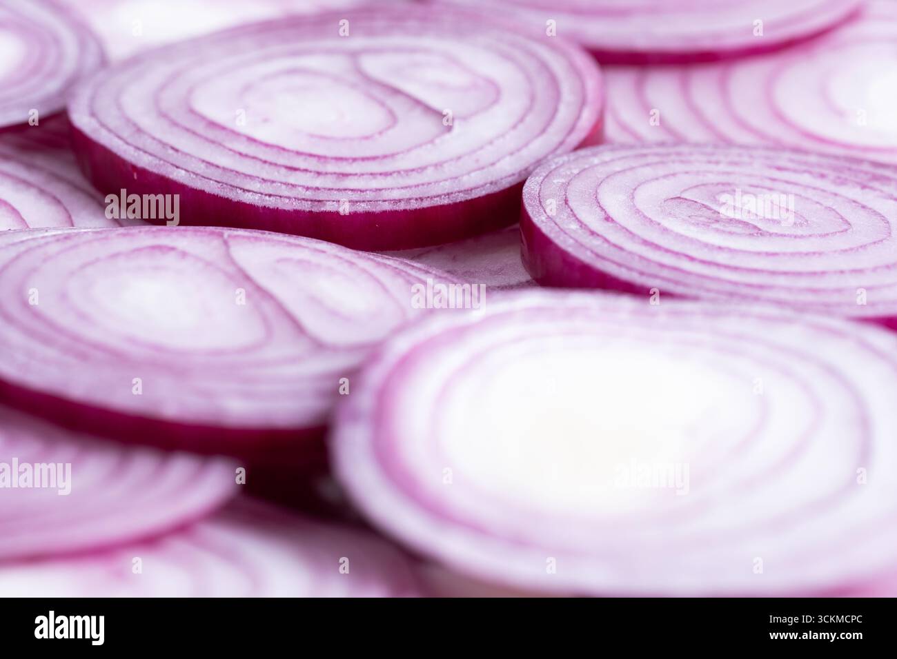 Sliced red onion rings on white background Stock Photo