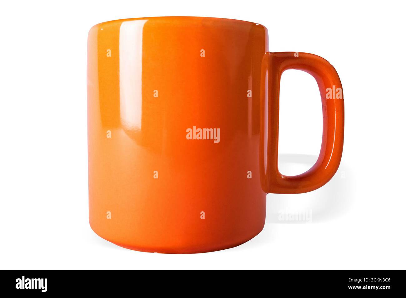 An orange coffe mug on white background, isolated. Stock Photo