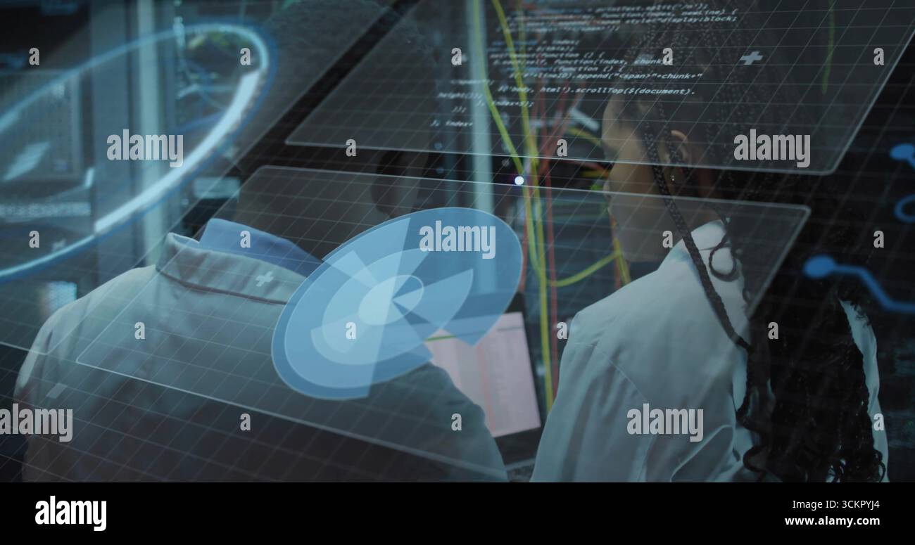 Analyzing virtual interface, two technicians in lab coats adjusting network cables in data center Stock Photo