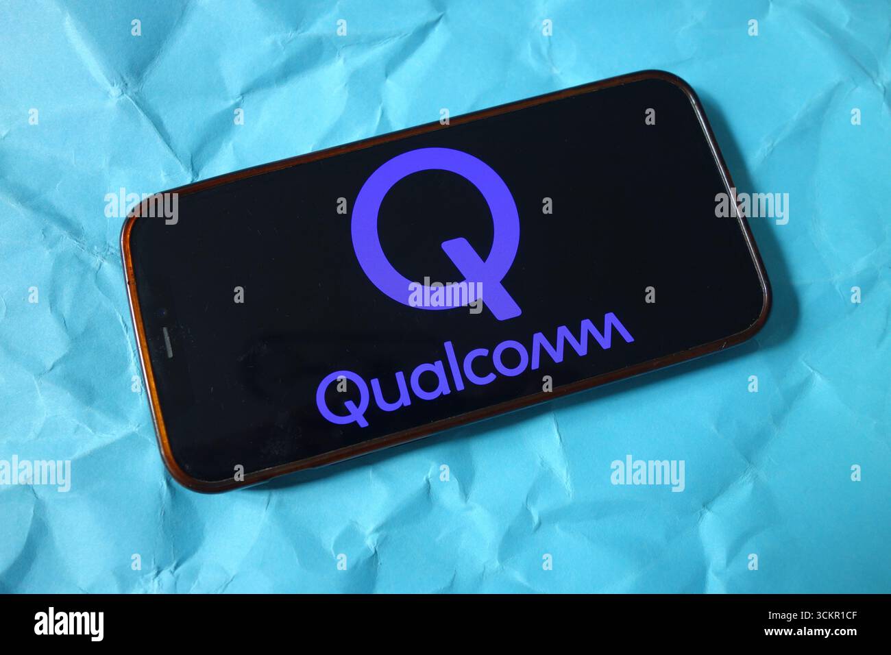 In this photo illustration, the Qualcomm company logo is seen displayed ...