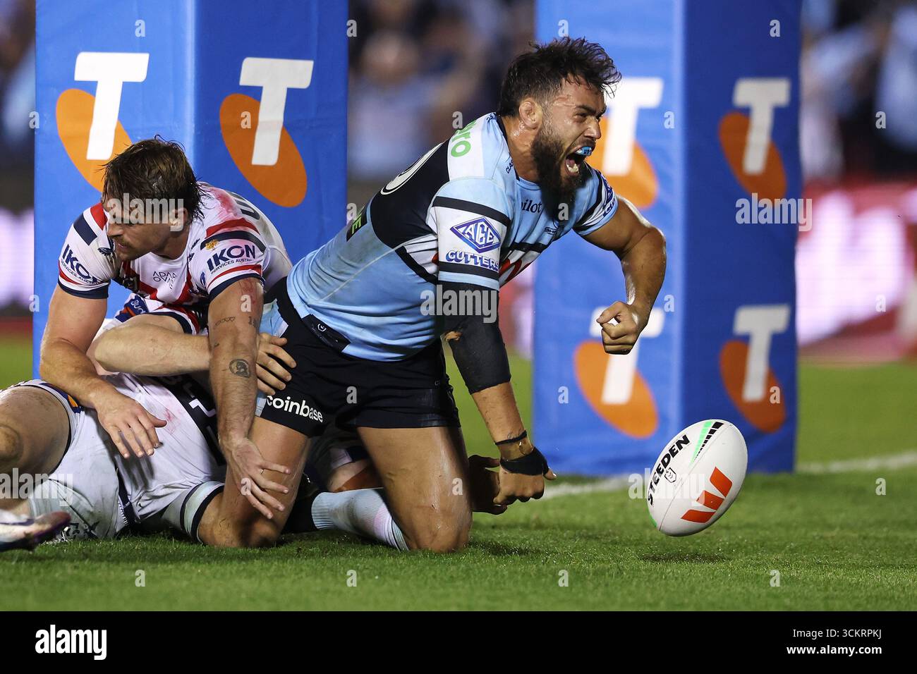 Toby Rudolf of the Sharks celebrates scoring a try during the NRL ...