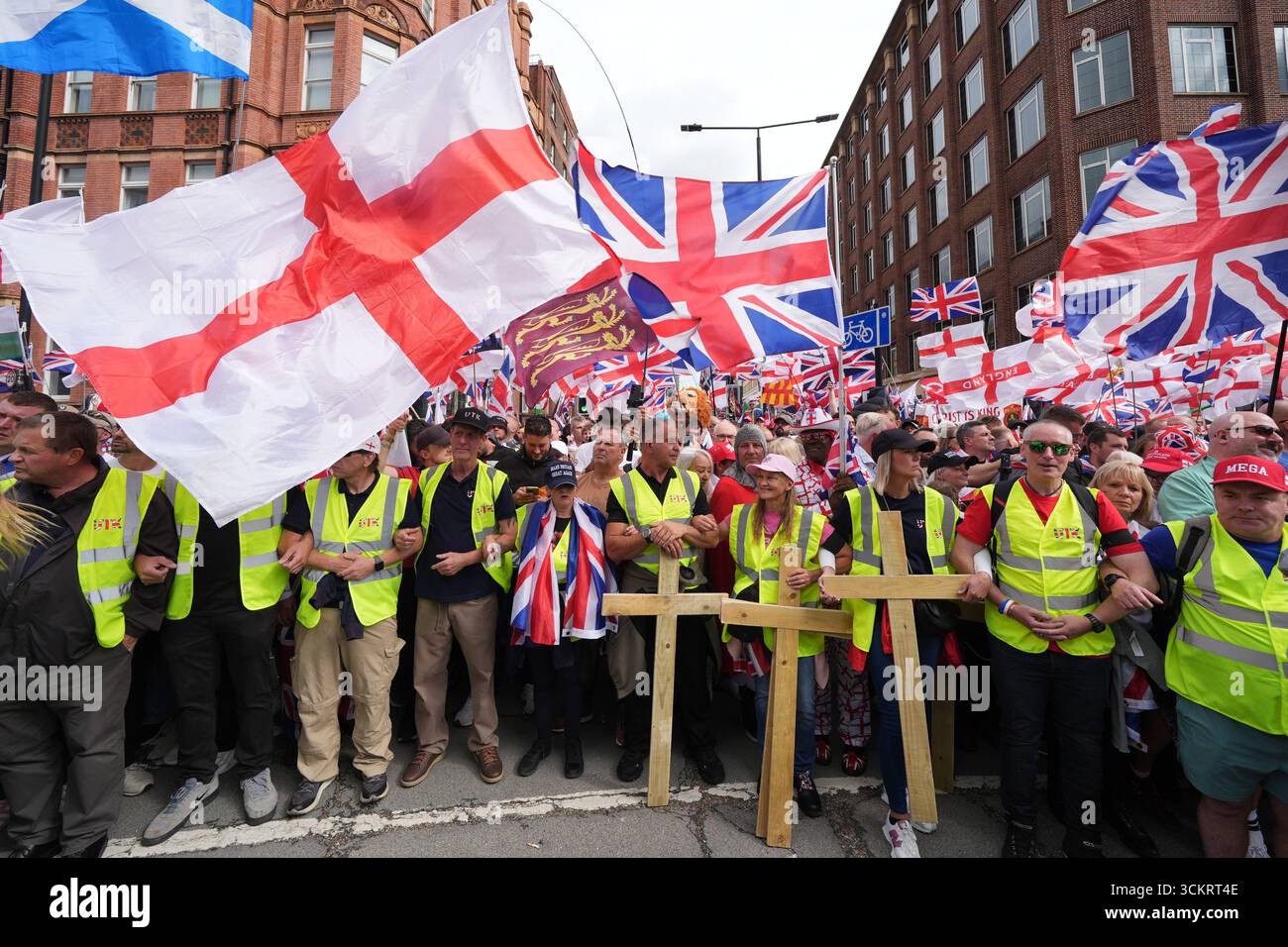 Activists fly Union flags and the St George Cross and carrying wooden ...