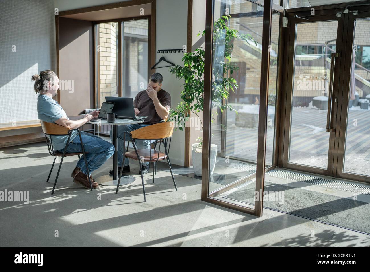 Two knowledgeable professionals collaborating effectively together in a modern workspace setting Stock Photo