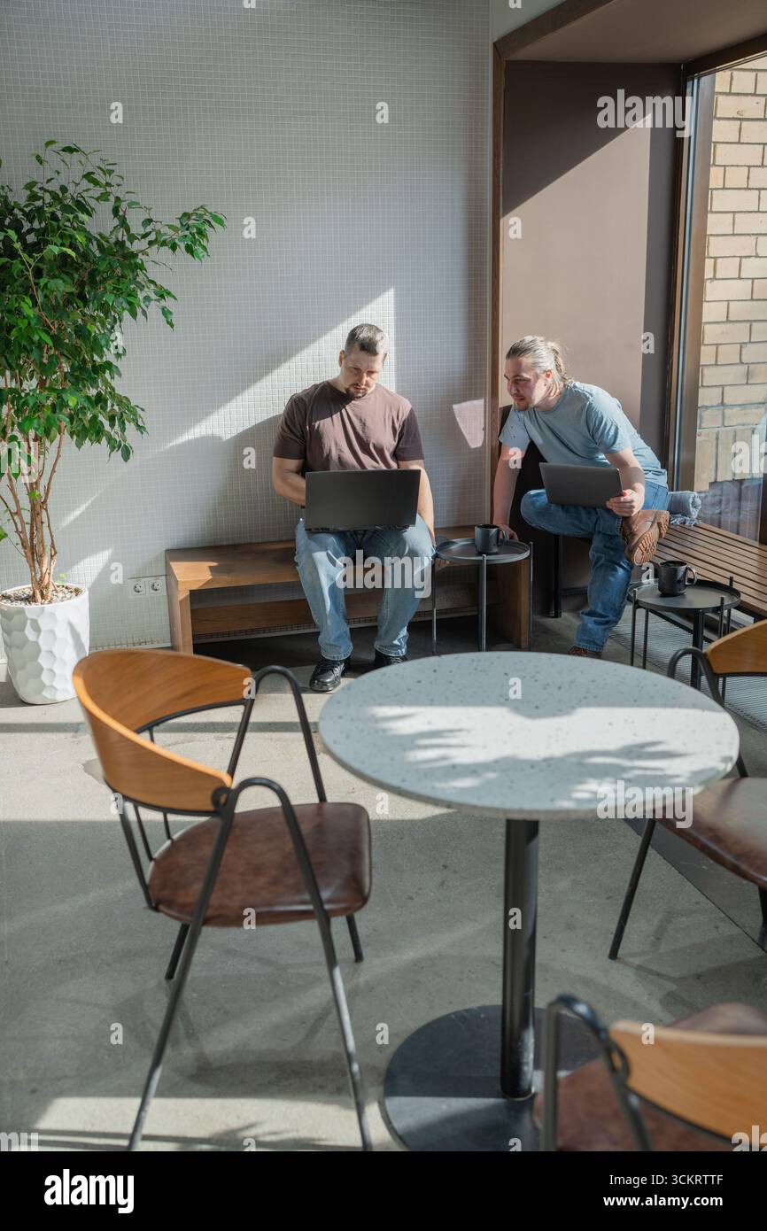 Two knowledgeable professionals collaborating effectively together in a modern workspace setting Stock Photo