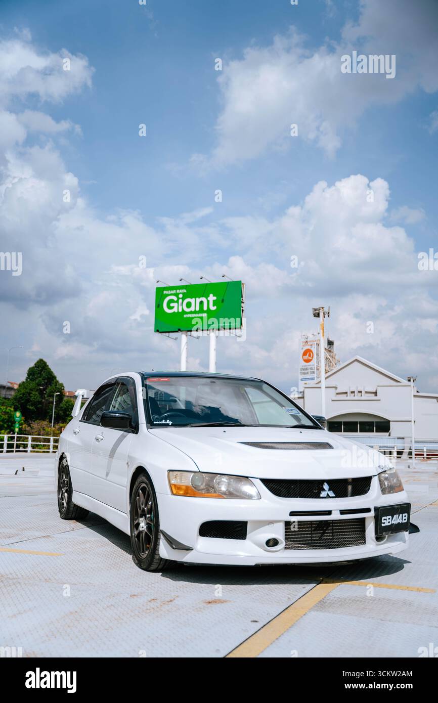 White Mitsubishi Evo 9 on an urban street Stock Photo