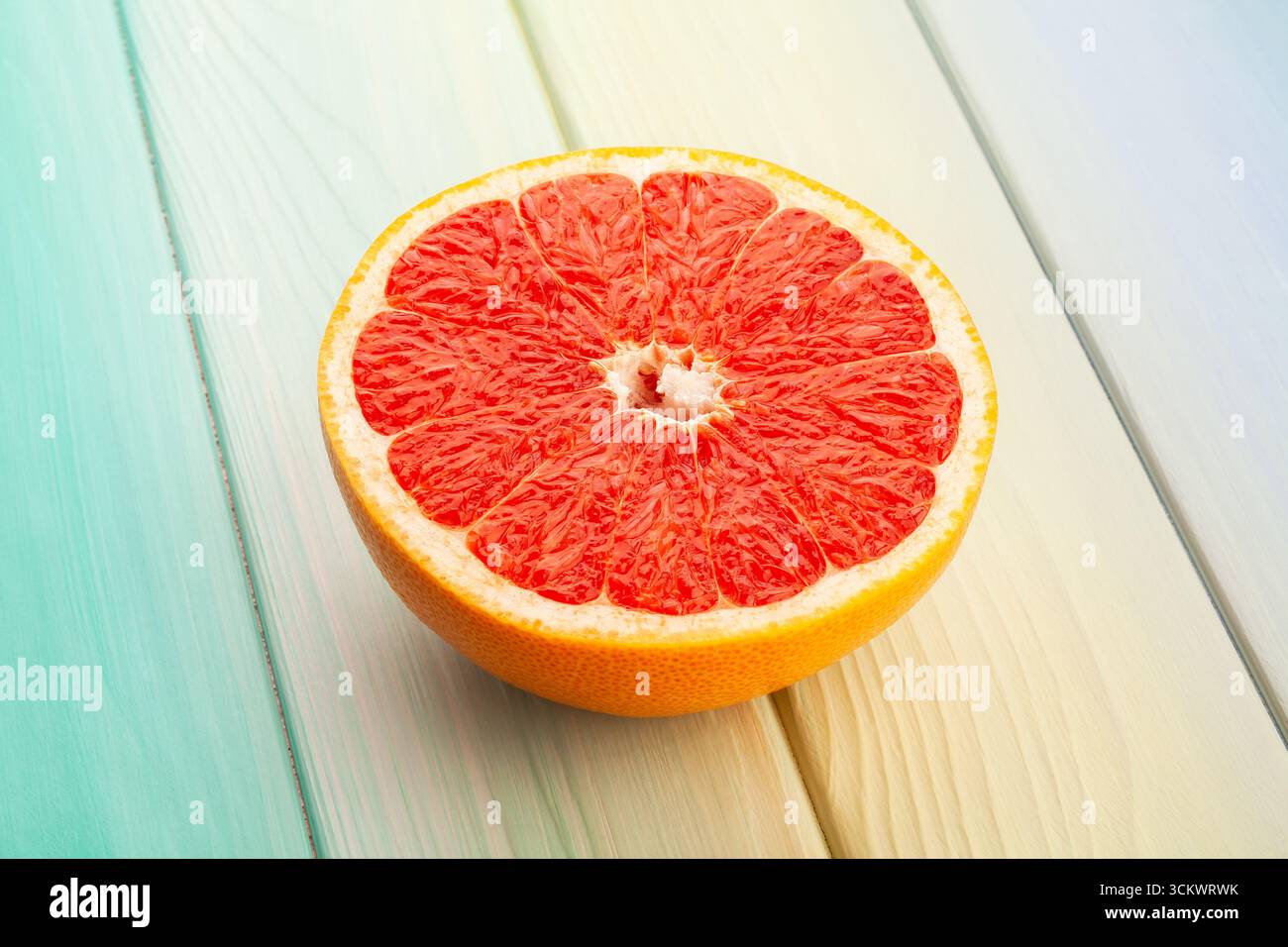 sliced grapefruit on blue wood background Stock Photo