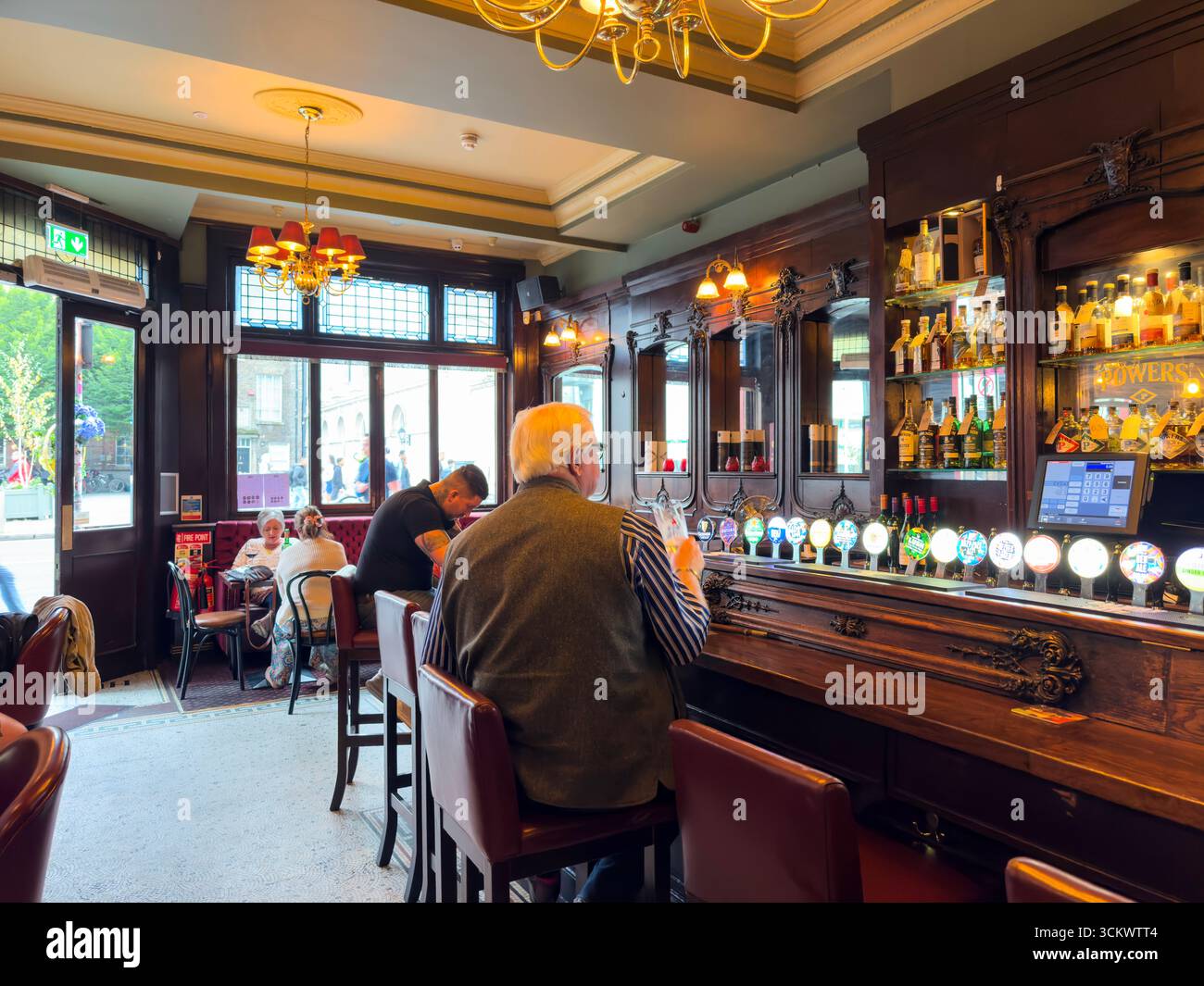 Customer drinking a pint of Heineken in a pub , The Oak, Parliament St, Temple Bar,  Dublin, Ireland - Smartphone Captured Stock Image