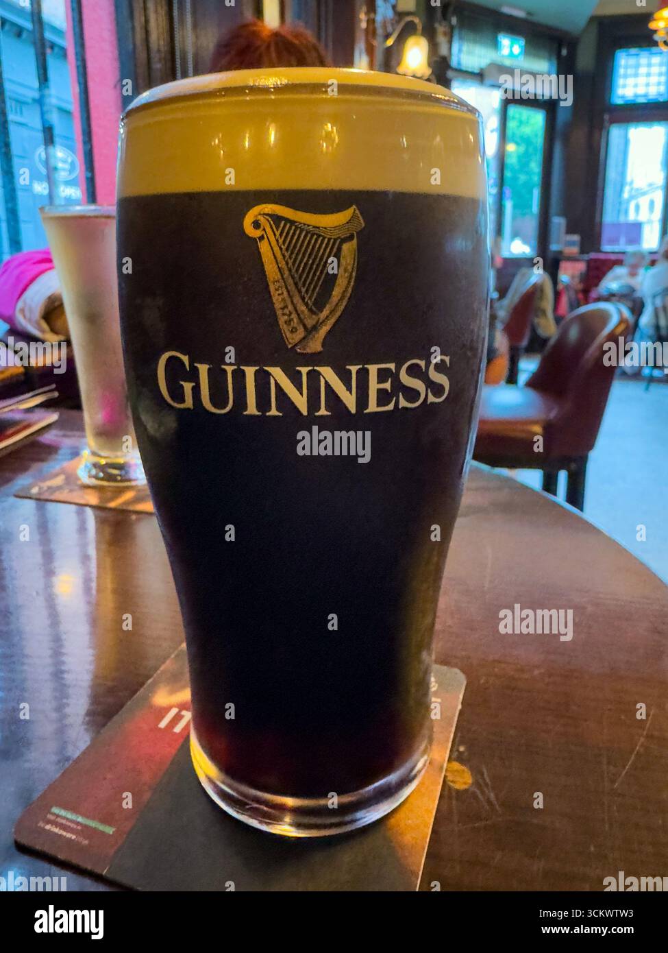 Full Pint with Beer head of Guinness beer in The Oak pub, Parliament St, Temple Bar,  Dublin, Ireland - Smartphone Captured Stock Image