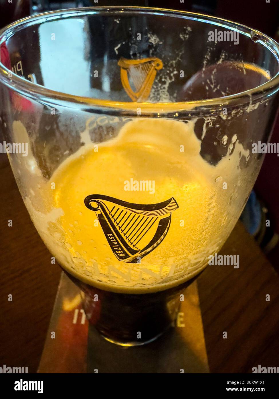 Half Pint of Guinness beer in The Oak pub, Parliament St, Temple Bar,  Dublin, Ireland - Smartphone Captured Stock Image