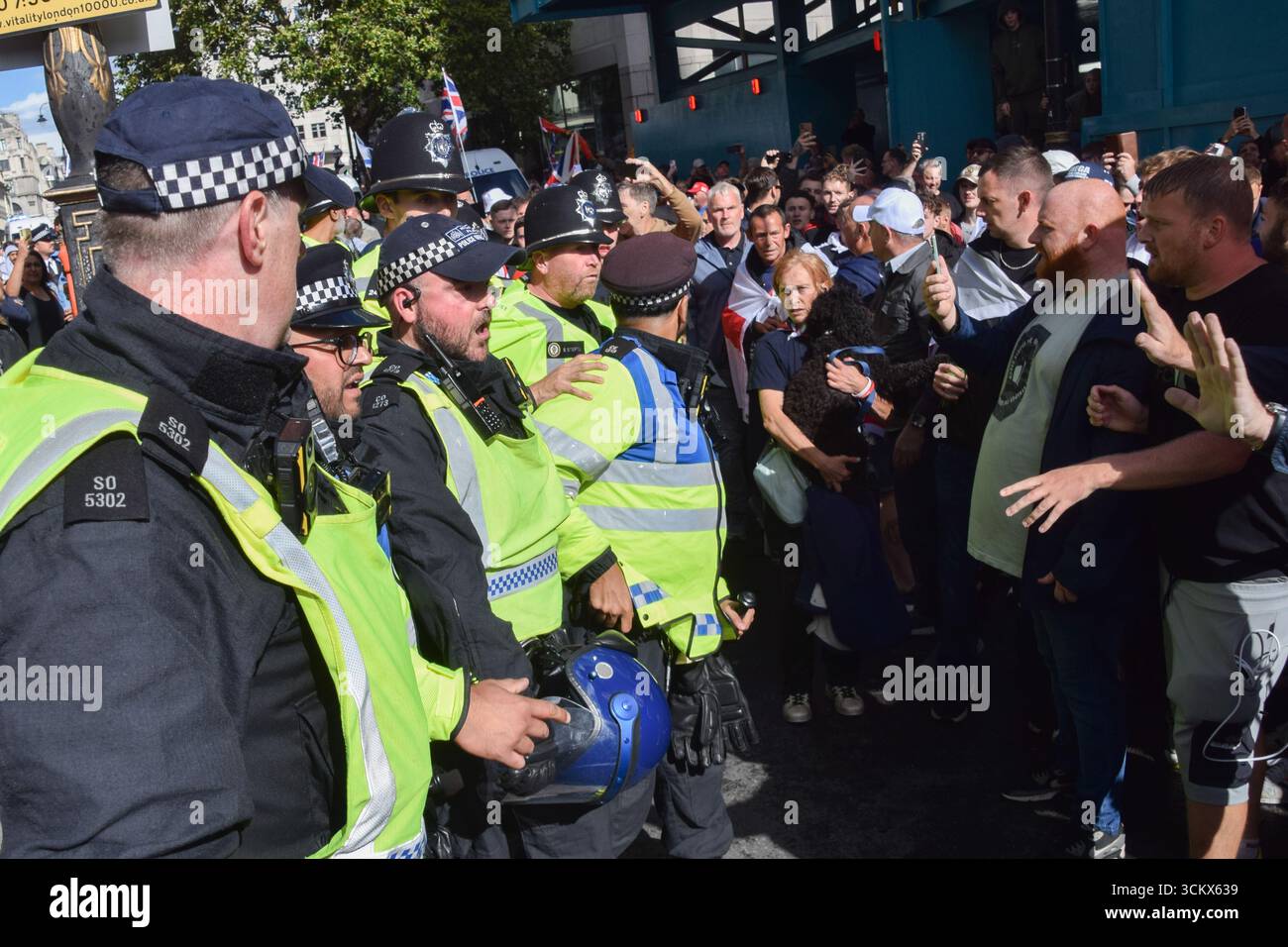 London, UK. 13th September 2025. Police in riot gear push back right ...