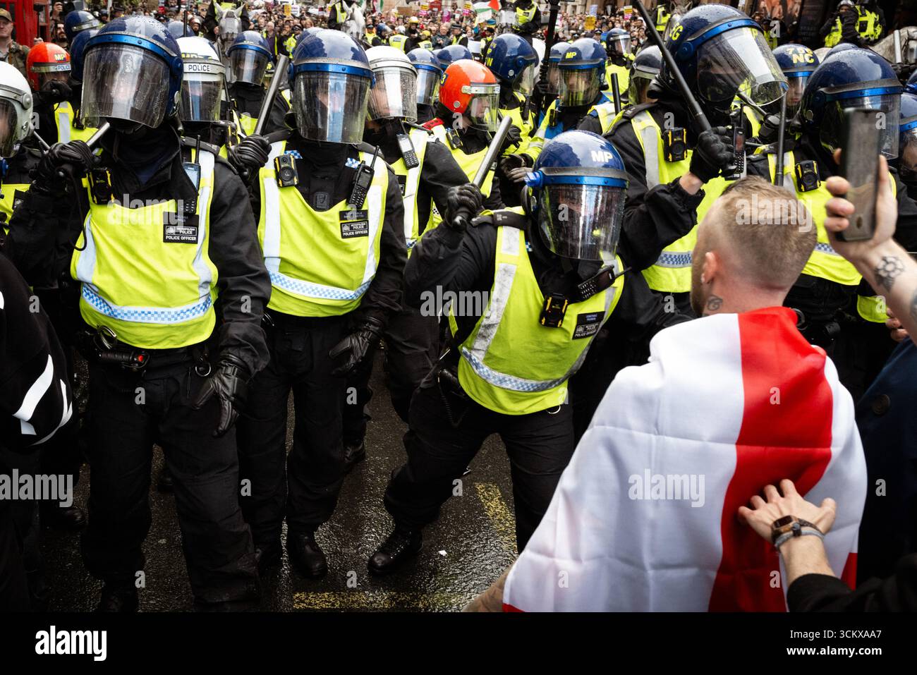 London, UK. 13th Sep, 2025. A man draped in an St Georges flag ...