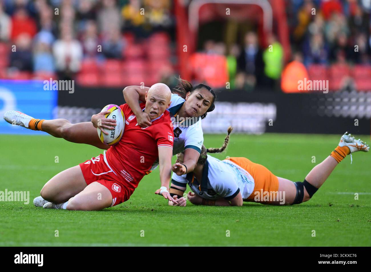 Canada's Olivia Apps, left, is being brought down by Australia's ...