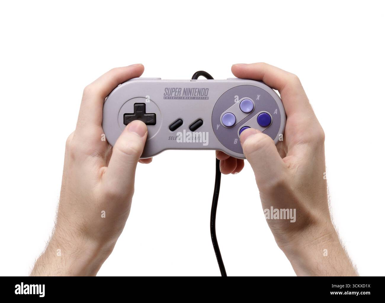 1991 Hands holding controller for Super Nintendo Entertainment System (SNES or Super NES) video game console Stock Photo