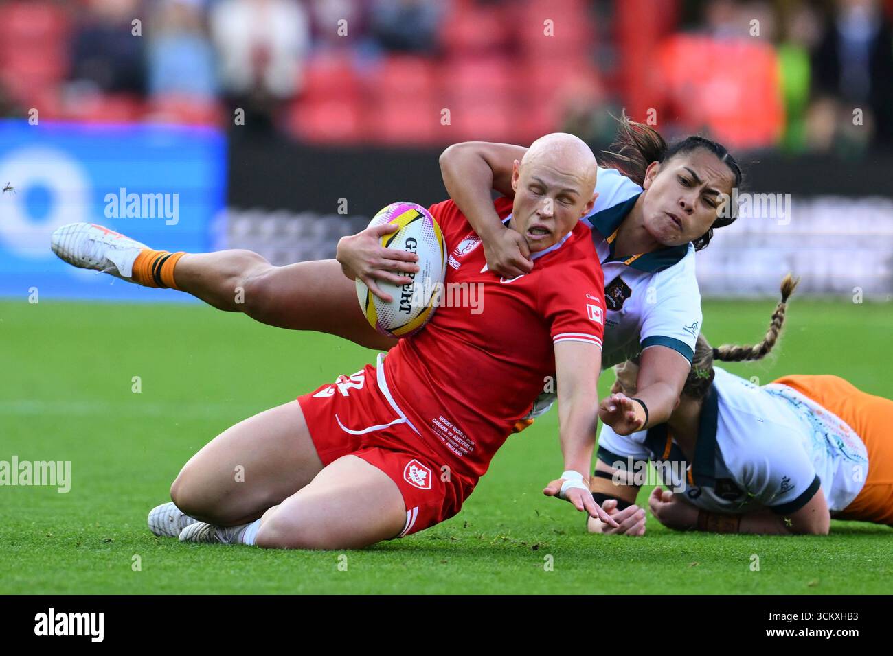 Canada's Olivia Apps, left, is being brought down by Australia's ...